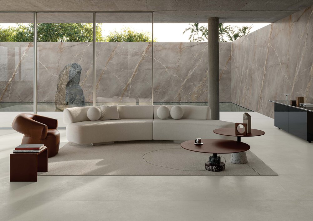 Highlight des Monats Mai 2026 Molarini Betonoptik moderner Wohnbereich mit Sofa großer Fensterfront und ruhigem Boden